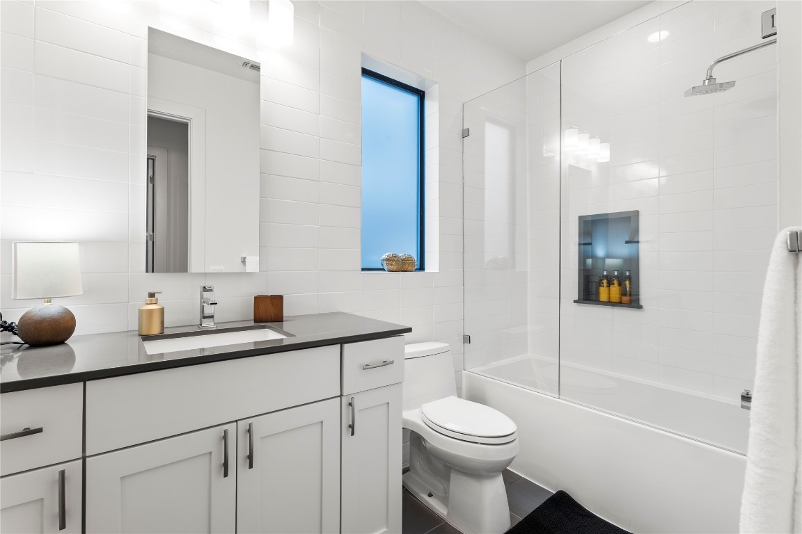 1105 East 12th Street Austin, TX 78702 - Photo 17 of 28 a bathroom with a sink a toilet and shower