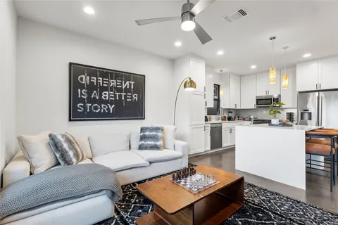 a living room with furniture and kitchen view