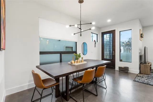 a large white kitchen with a table and chairs