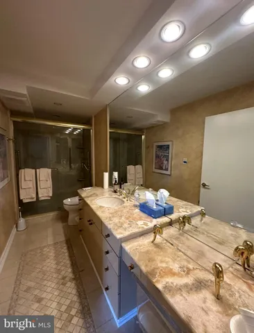 a spacious bathroom with a granite countertop sink and a mirror