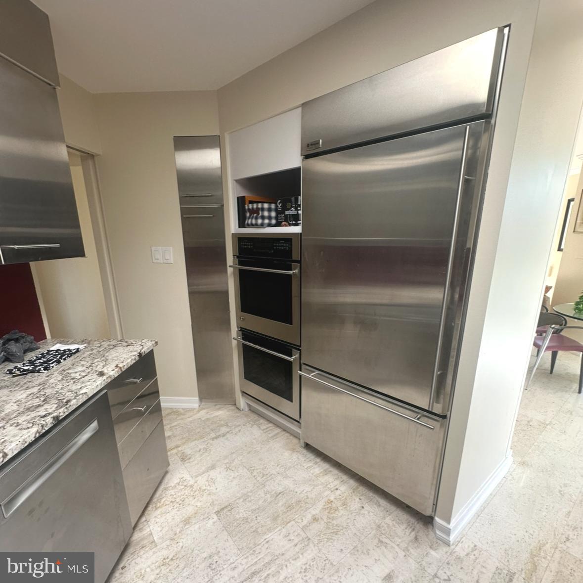 8302 Old York Road, Unit C61 Elkins Park, PA 19027 - Photo 9 of 25 a kitchen with granite countertop a refrigerator and a sink