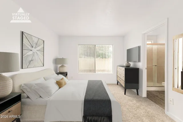 a bed room with a bed and a television