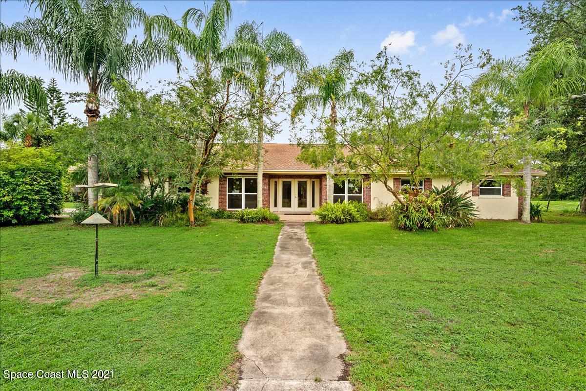 2825 Corey Road Malabar, FL 32950 - Photo 1 of 44 a front view of a house with garden