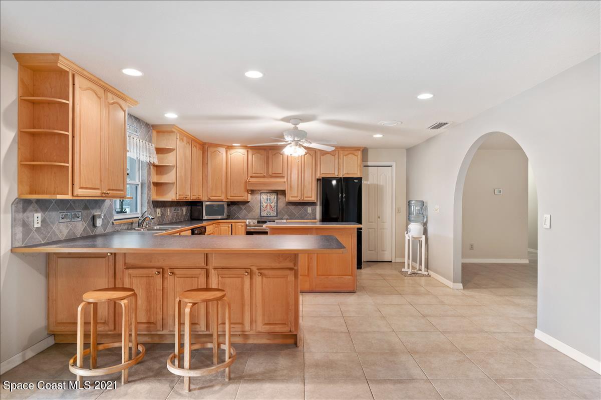 2825 Corey Road Malabar, FL 32950 - Photo 11 of 44 a large kitchen with a table and chairs
