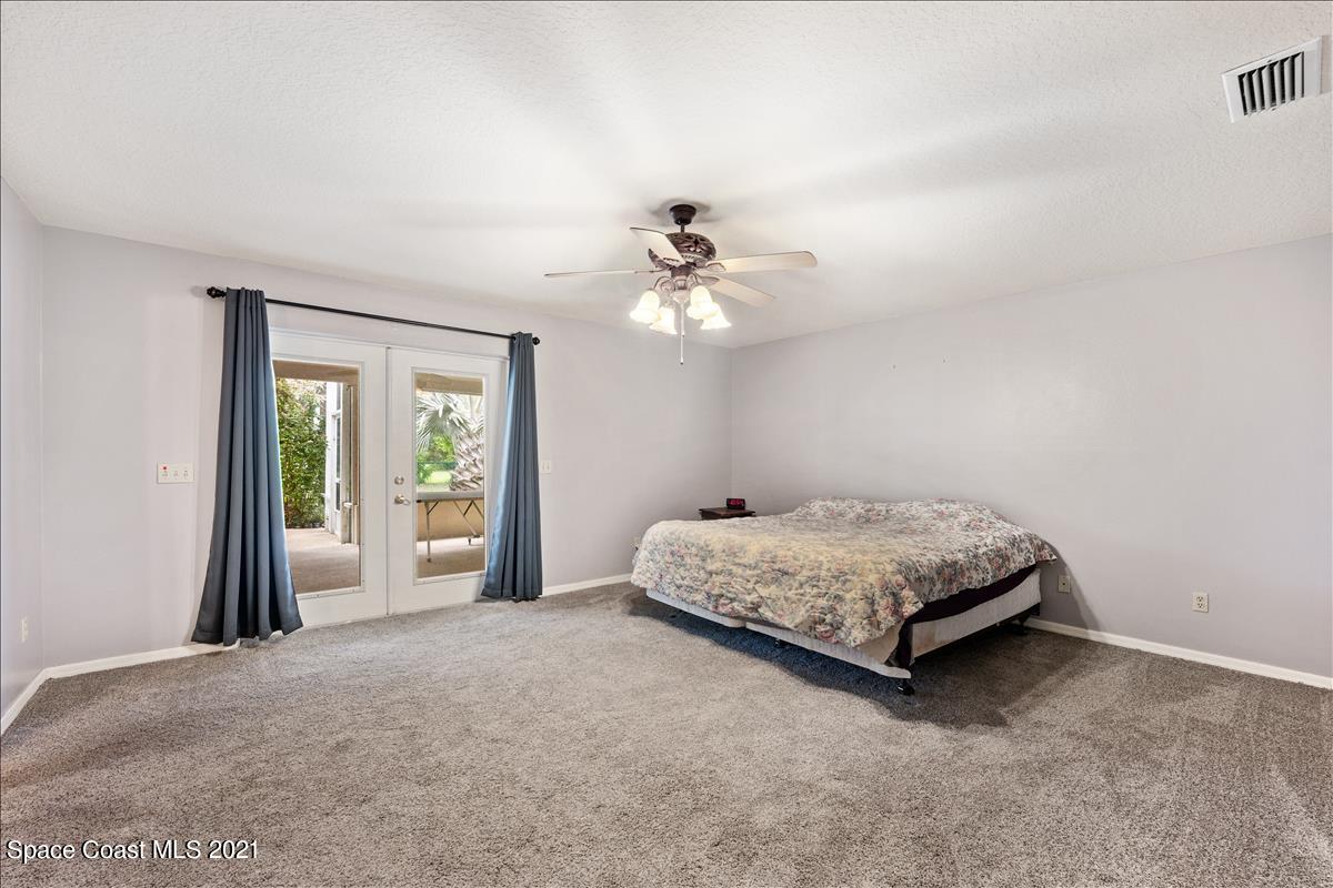 2825 Corey Road Malabar, FL 32950 - Photo 13 of 44 a living room with furniture and a chandelier