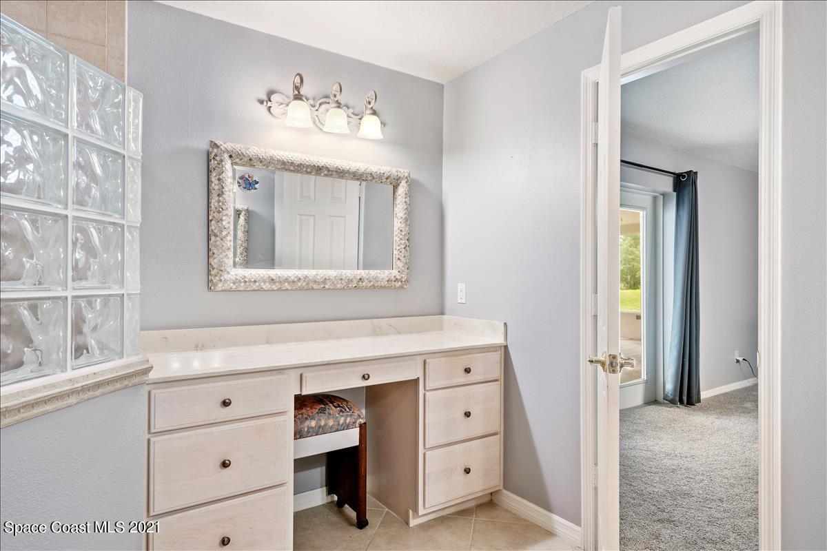 2825 Corey Road Malabar, FL 32950 - Photo 16 of 44 a bathroom with a sink mirror and a window