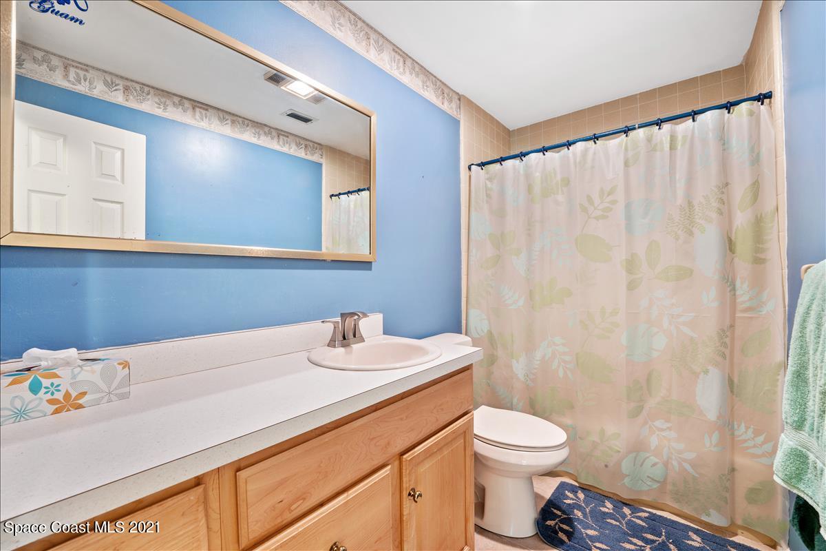 2825 Corey Road Malabar, FL 32950 - Photo 21 of 44 a bathroom with a sink a toilet and a mirror