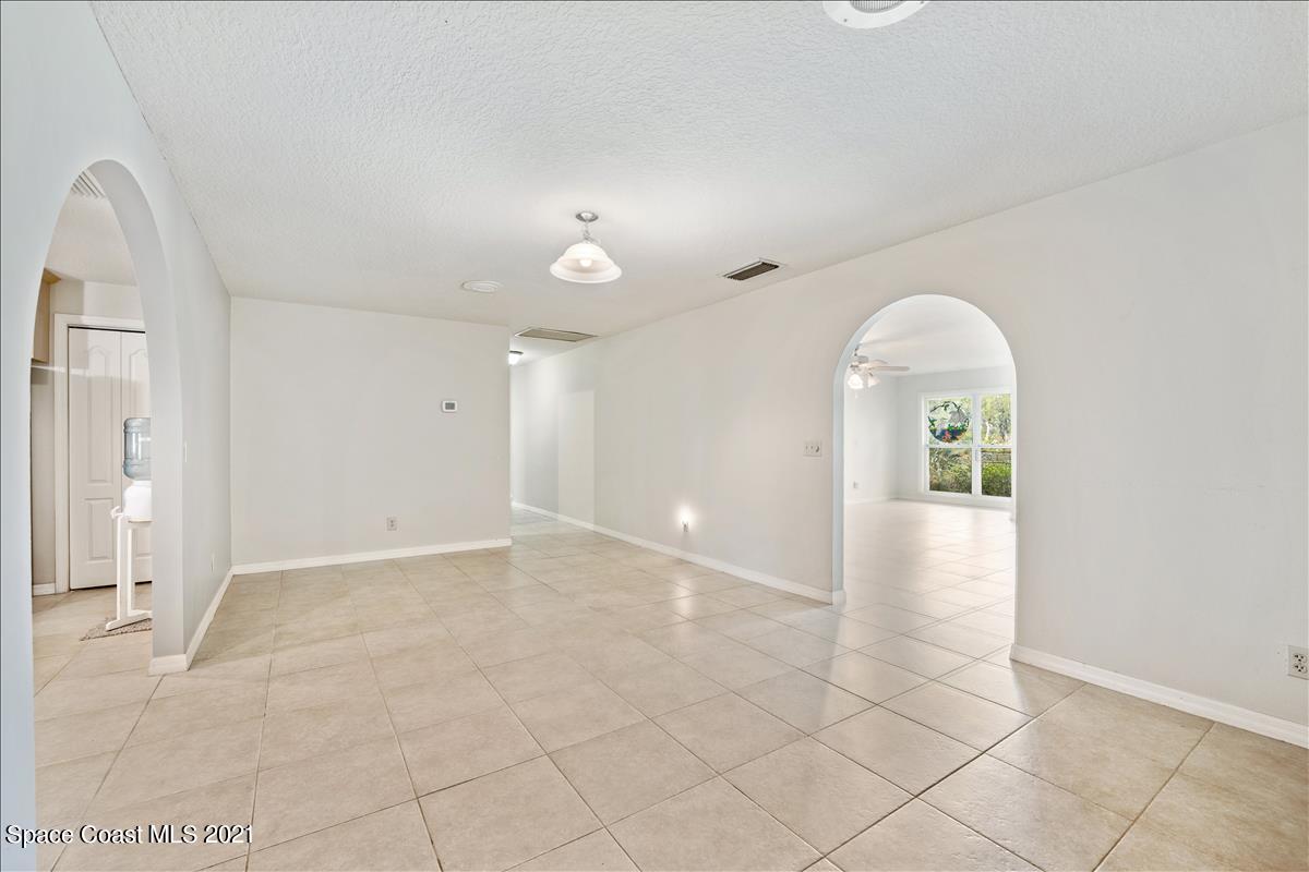 2825 Corey Road Malabar, FL 32950 - Photo 25 of 44 an empty room with entrance and mirror