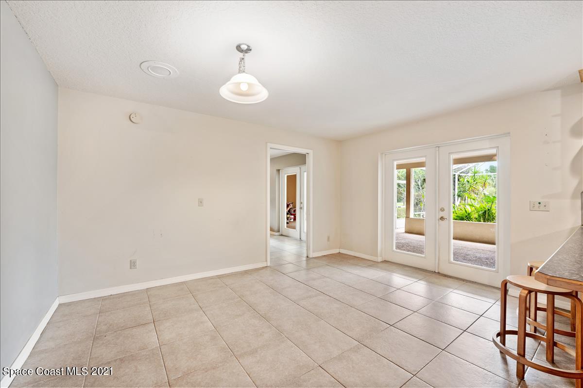 2825 Corey Road Malabar, FL 32950 - Photo 27 of 44 an empty room with windows and wooden floor