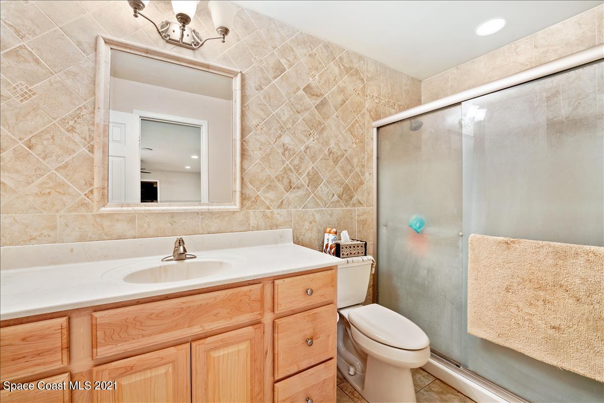 2825 Corey Road Malabar, FL 32950 - Photo 28 of 44 a bathroom with a sink toilet and shower