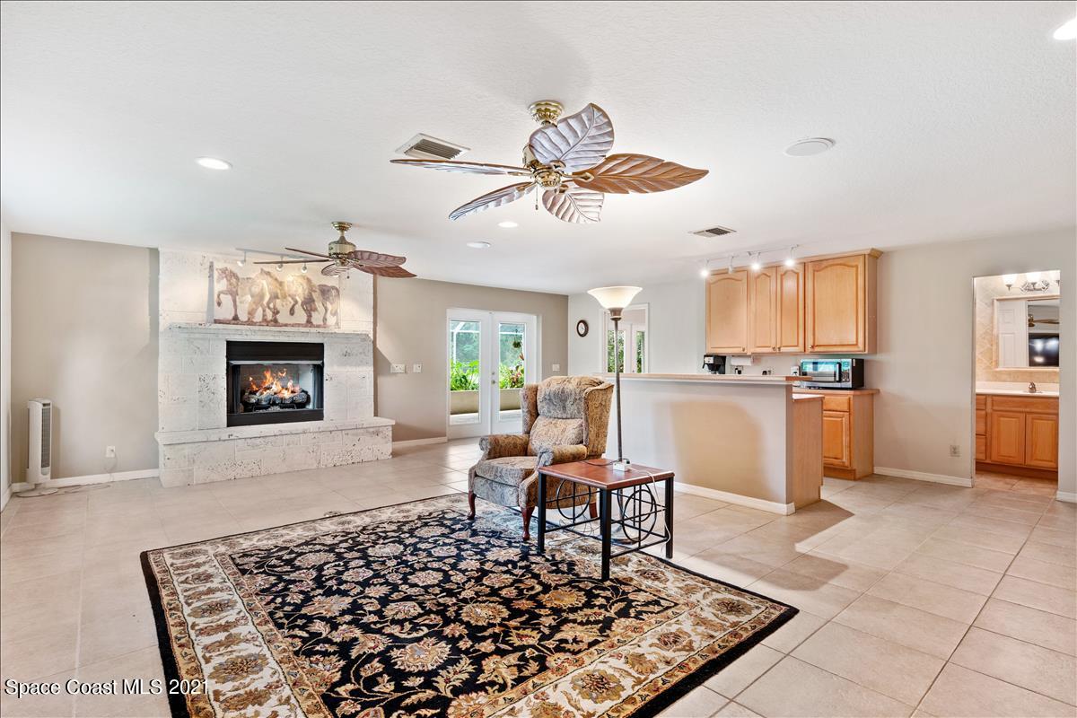 2825 Corey Road Malabar, FL 32950 - Photo 5 of 44 a living room with furniture and a fireplace
