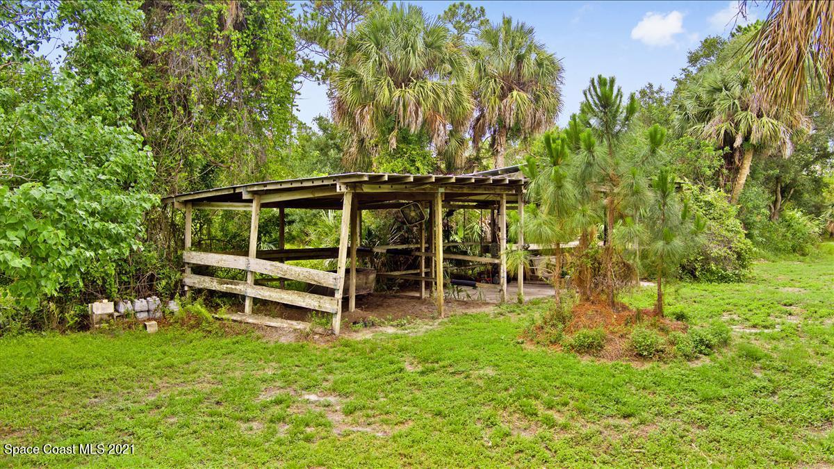 2825 Corey Road Malabar, FL 32950 - Photo 42 of 44 a view of a backyard with wooden fence and a bench