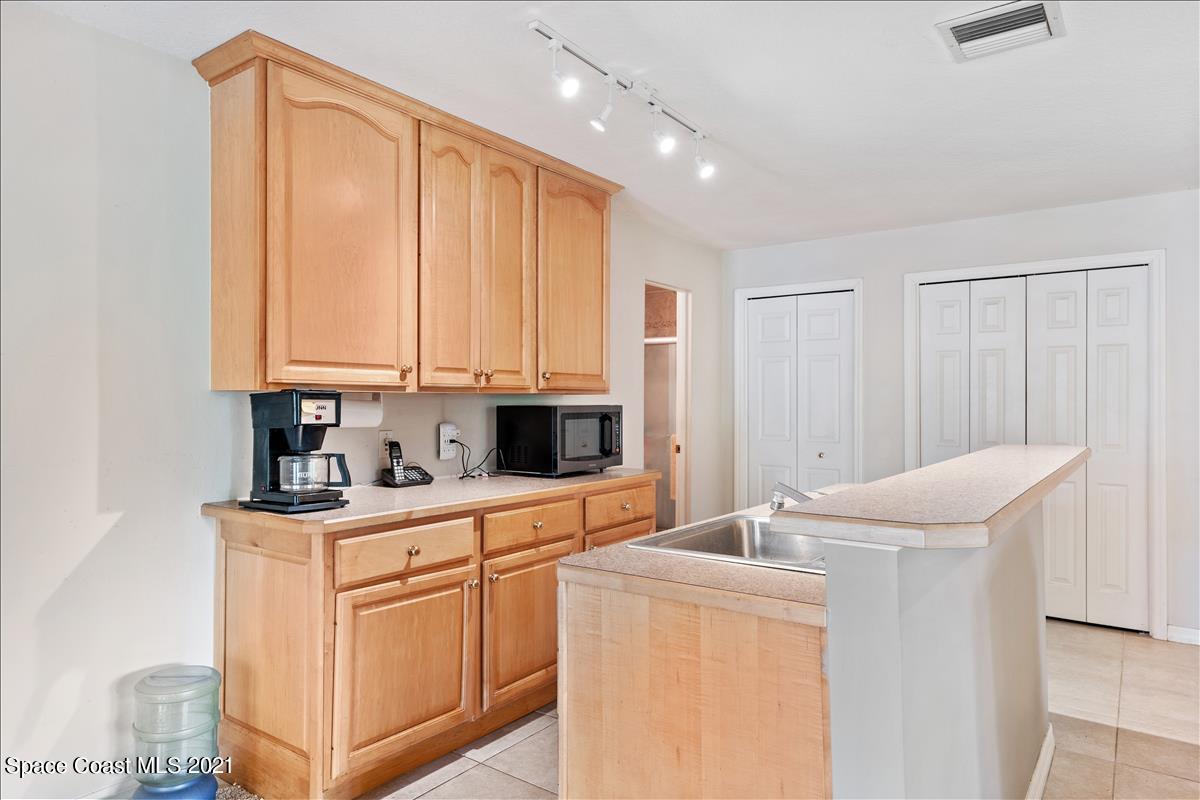 2825 Corey Road Malabar, FL 32950 - Photo 7 of 44 a room with cabinets and washer dryer