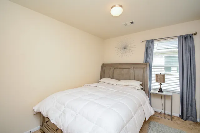 a bathroom with a toilet and a shower curtain