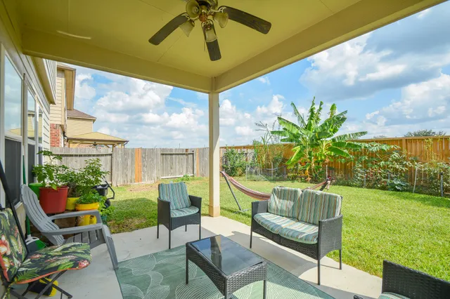 a view of a chair and table in backyard of the house