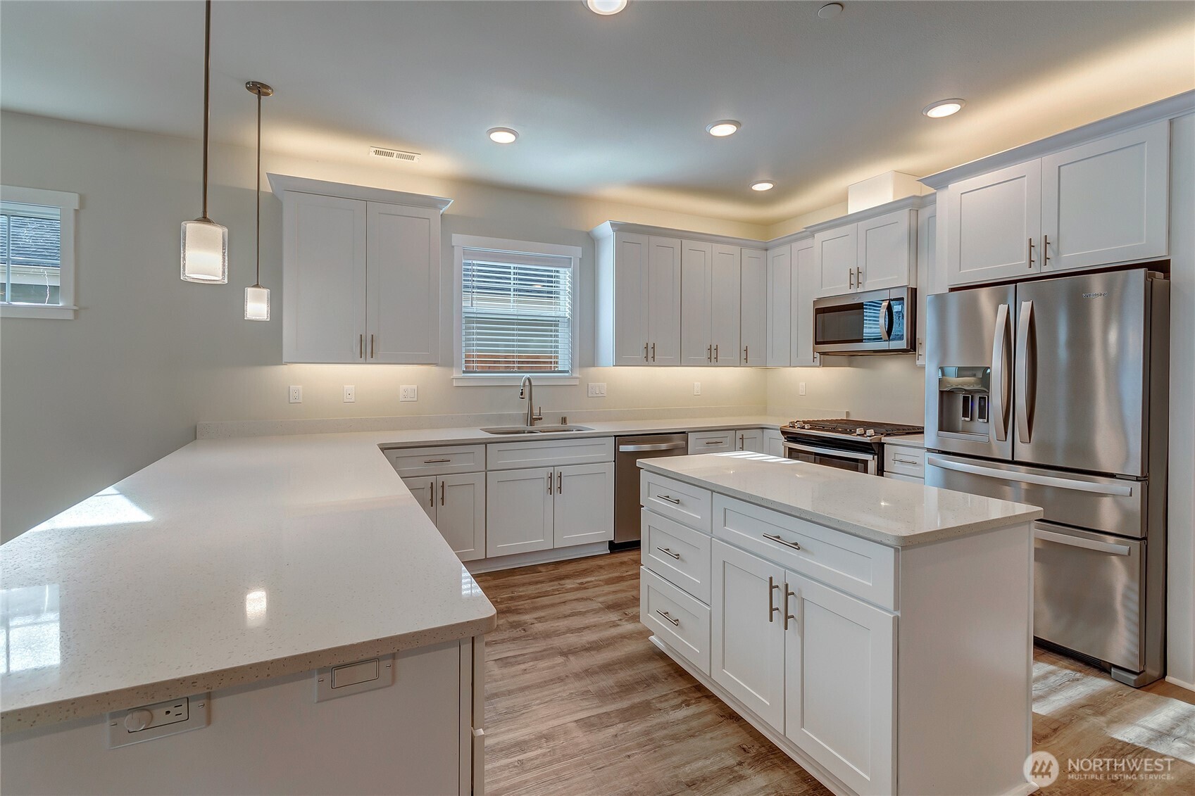 2213 Trail View Street Northeast Olympia, WA 98506 - Photo 12 of 40 a kitchen with a sink a refrigerator and a stove top oven