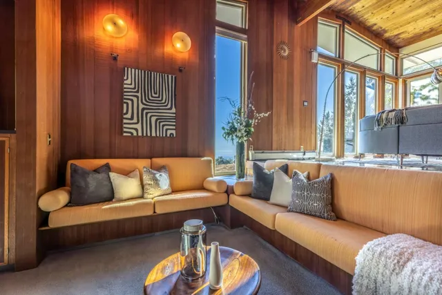 a living room with furniture gym equipment and a rug