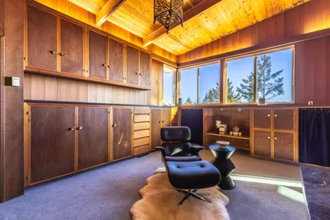 a bedroom with a bed and a chair