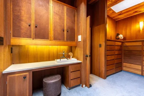 a bathroom with a granite countertop toilet sink and mirror