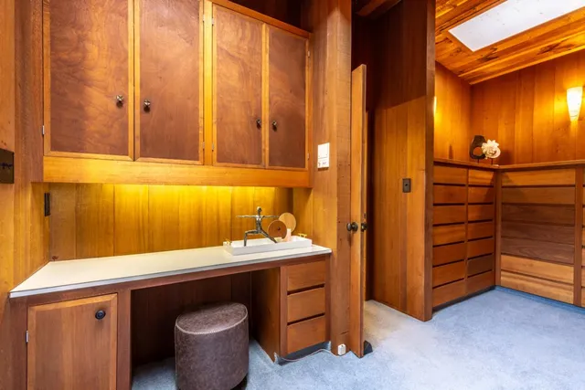 a bathroom with a granite countertop toilet sink and mirror