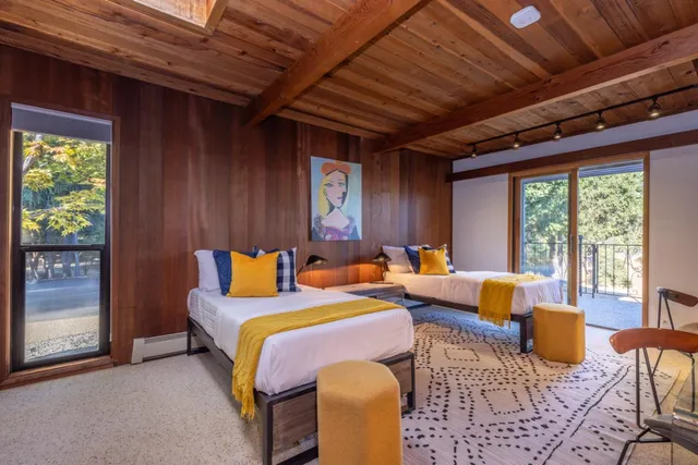 a bed sitting in a bedroom next to a window