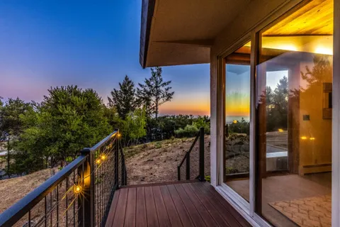 a view of a porch with chairs and potted plants