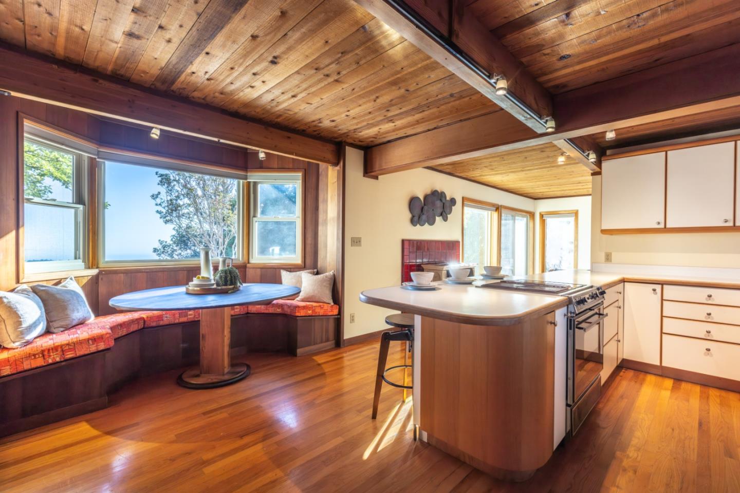 800 Rancho Prieta Road Los Gatos, CA 95033 - Photo 53 of 55 a view of a kitchen with kitchen island a stove a sink a dining table and chairs with wooden floor