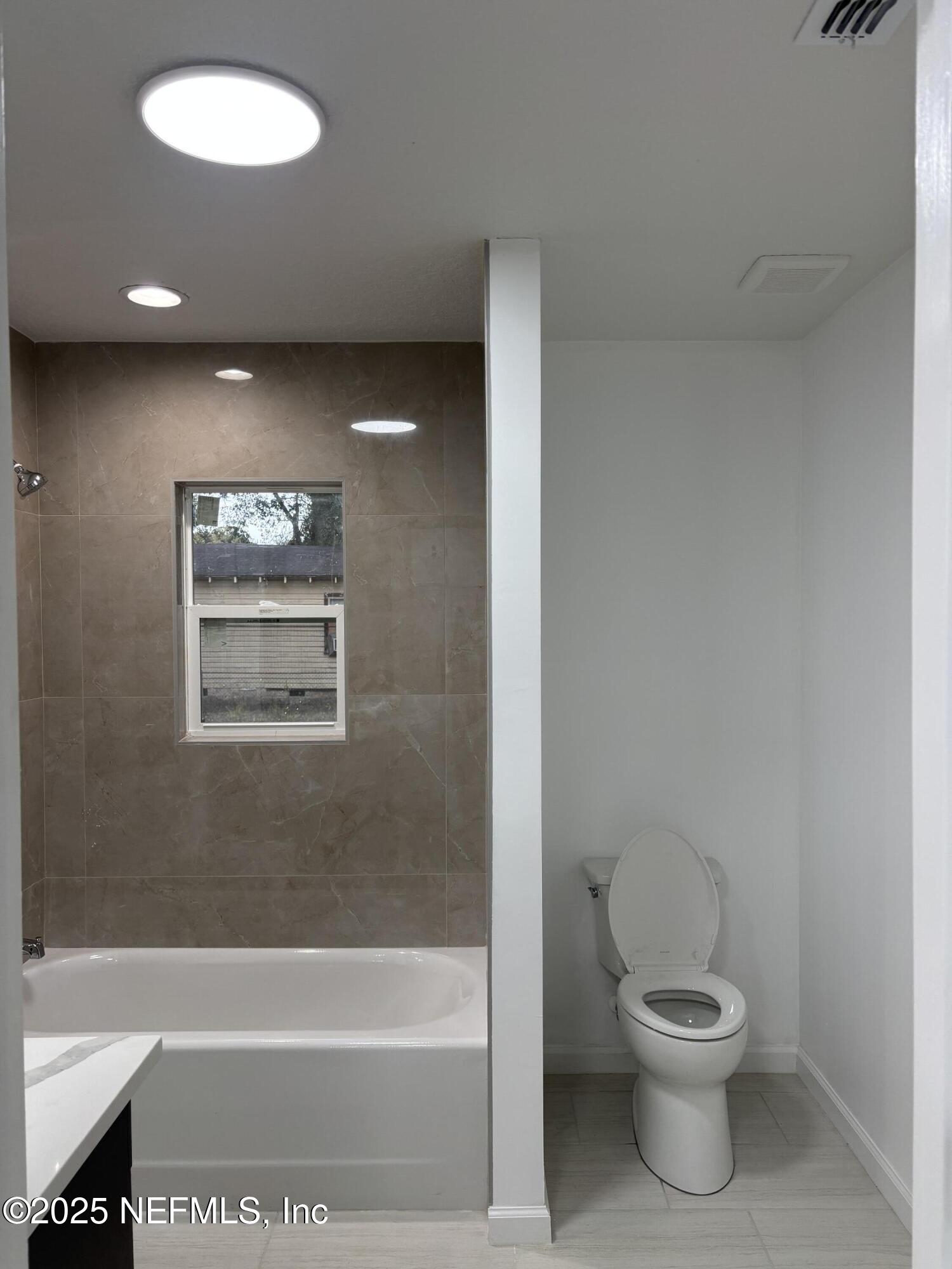 1992 West 20th Street Jacksonville, FL 32209 - Photo 16 of 28 a bathroom with a toilet and a bathtub