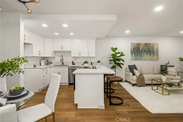 a living room with kitchen island furniture and a potted plant