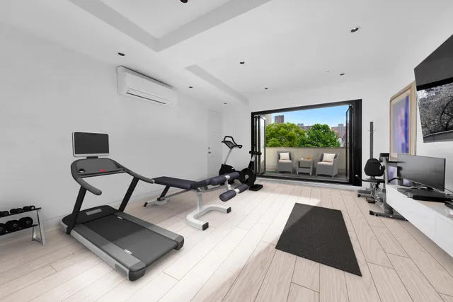 a room with stainless steel appliances lots of white furniture