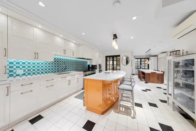 a bathroom with a sink a large mirror and a bathtub