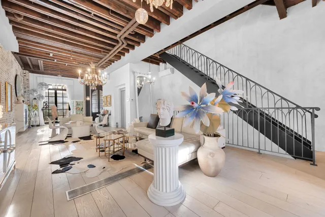 a view of a hallway and a livingroom with wooden floor