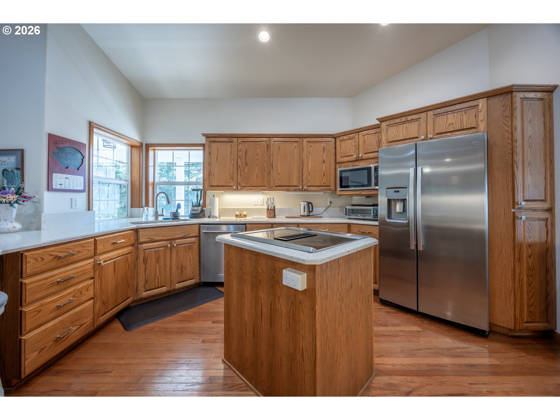 2193 13th Street Florence, OR 97439 - Photo 21 of 48 a kitchen with stainless steel appliances granite countertop a refrigerator a sink a stove a microwave and island