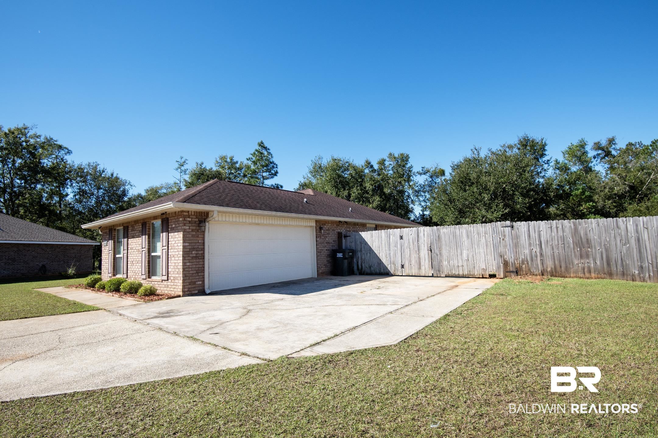 15345 Fremont Court Foley, AL 36535 - Photo 4 of 35 View of property exterior with a garage and a yard