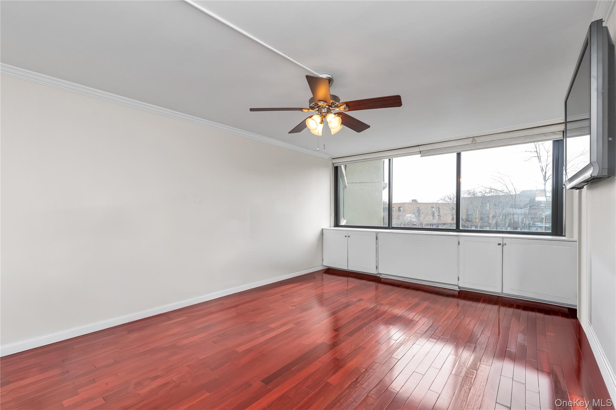 1 Bay Club Drive, Unit 4R Queens, NY 11360 - Photo 12 of 24 wooden floor in an empty room with a window