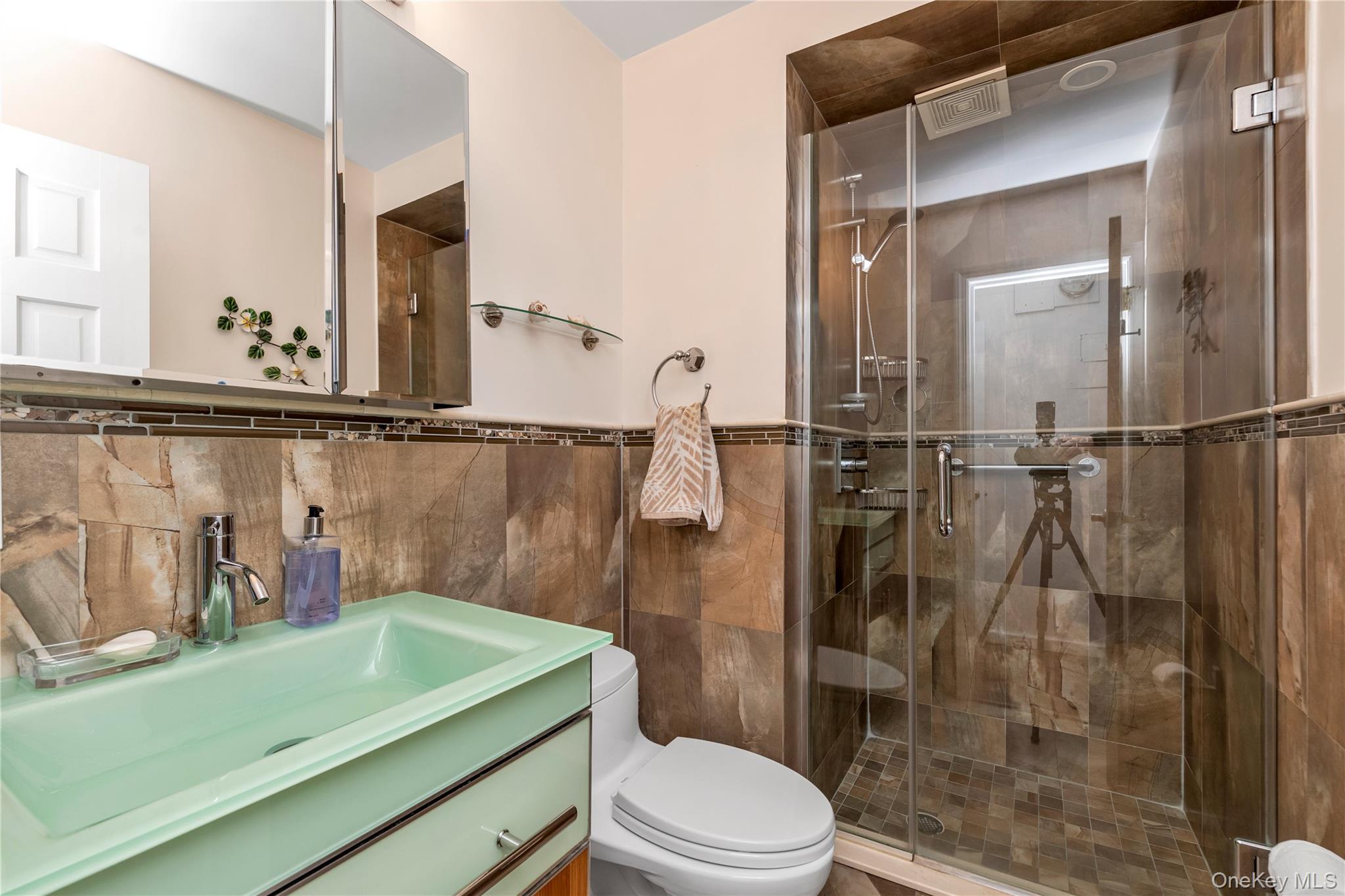 1 Bay Club Drive, Unit 4R Queens, NY 11360 - Photo 14 of 24 a bathroom with a sink and a mirror