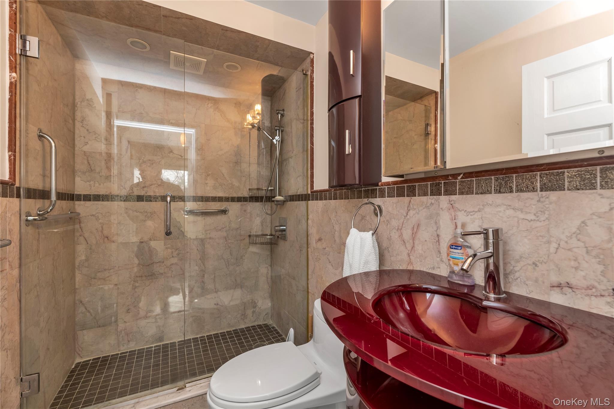 1 Bay Club Drive, Unit 4R Queens, NY 11360 - Photo 16 of 24 a bathroom with a sink a toilet and shower