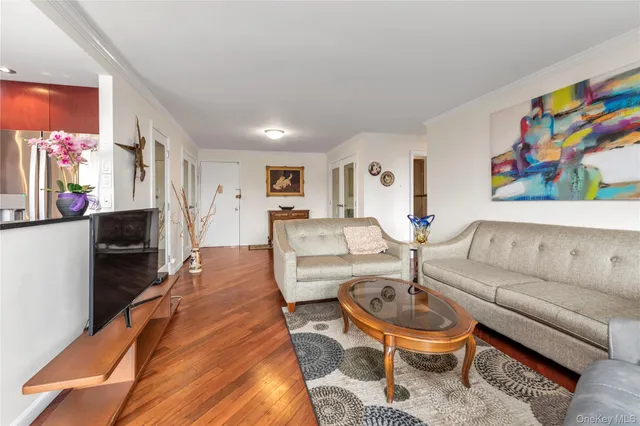 a living room with furniture a rug and a flat screen tv