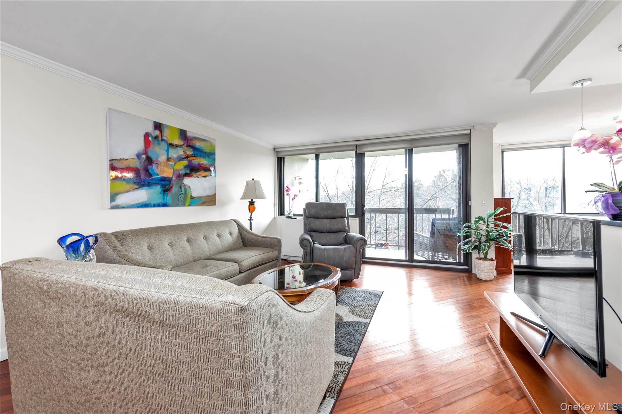 1 Bay Club Drive, Unit 4R Queens, NY 11360 - Photo 6 of 24 a living room with furniture large window and a potted plant on the table