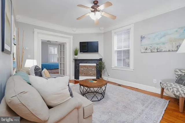 a bedroom with a bed a window and dresser