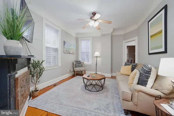 a bedroom with a bed and a lamp on dresser