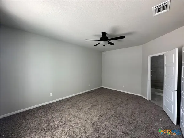 a view of room with a ceiling fan and window