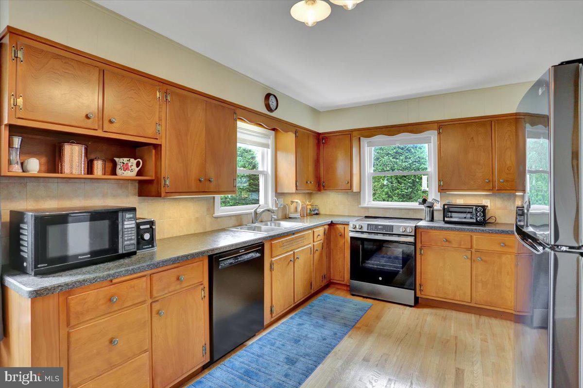 202 Old Fritztown Road Reading, PA 19607 - Photo 8 of 30 a kitchen with stainless steel appliances granite countertop wooden cabinets a sink and a stove