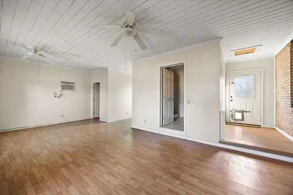 a view of a livingroom with wooden floor and a ceiling fan