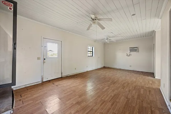 wooden floor in an empty room with a window