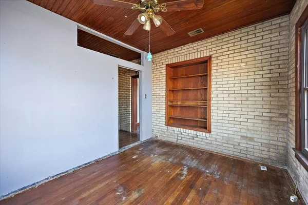 a view of a room that has wooden door and a window