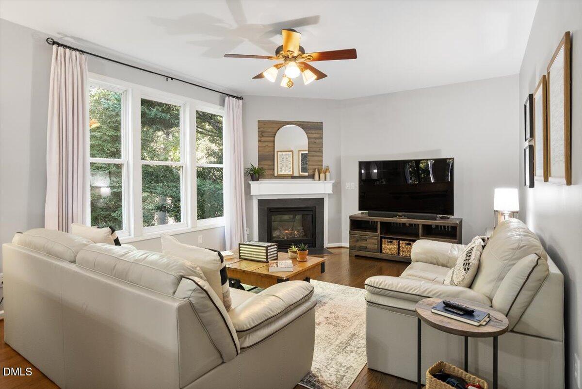 2220 Spruce Shadows Lane Raleigh, NC 27614 - Photo 13 of 29 a living room with furniture a fireplace and a flat screen tv