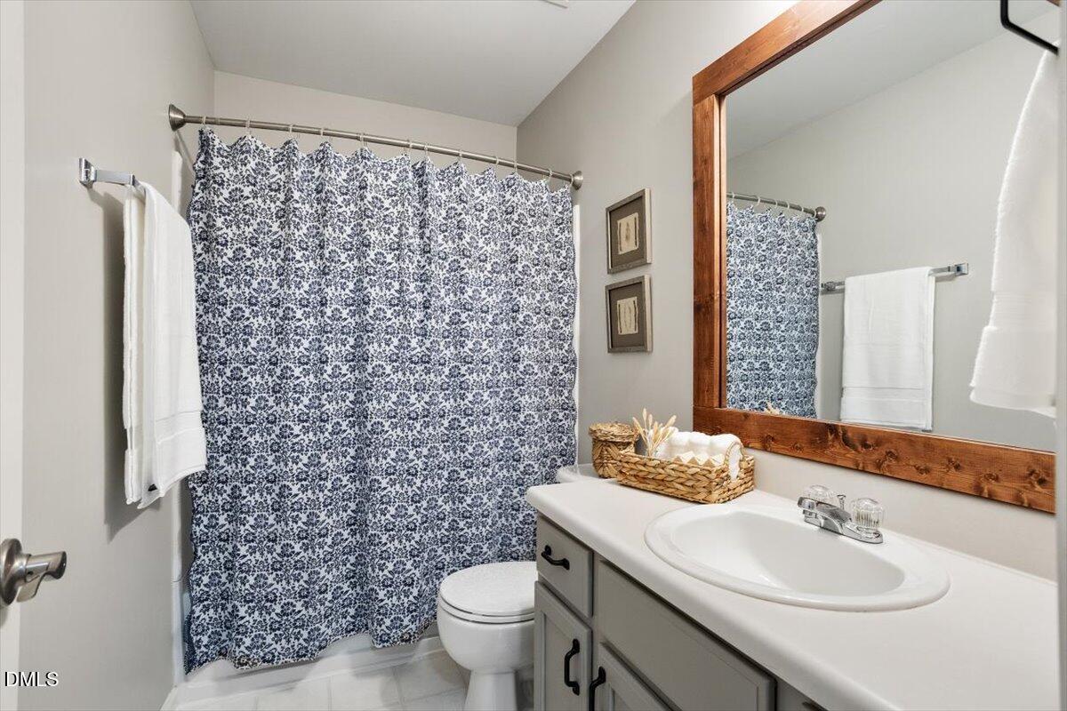 2220 Spruce Shadows Lane Raleigh, NC 27614 - Photo 23 of 29 a bathroom with a sink toilet and a mirror