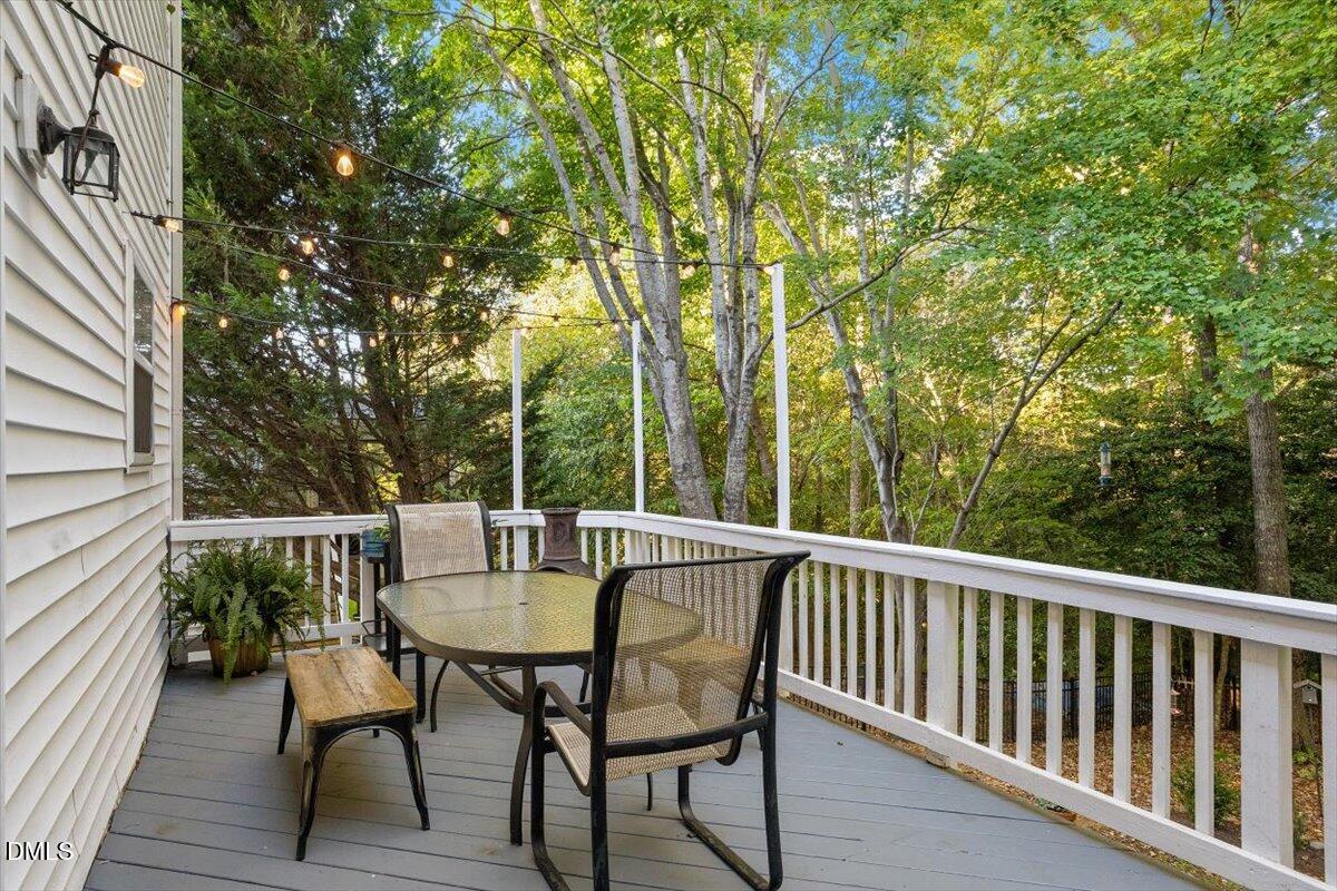 2220 Spruce Shadows Lane Raleigh, NC 27614 - Photo 25 of 29 a view of a patio with table and chairs and wooden floor