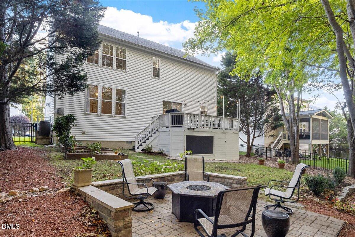 2220 Spruce Shadows Lane Raleigh, NC 27614 - Photo 26 of 29 a front view of a house with garden and chairs